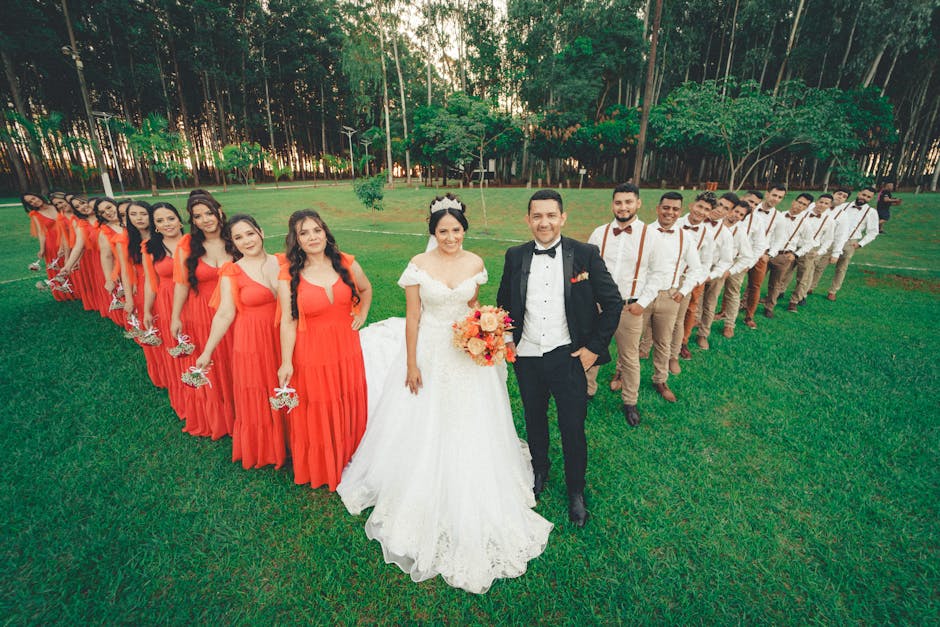 Bride and groom with bridesmaids and groomsmen outdoors in a beautiful forest setting.