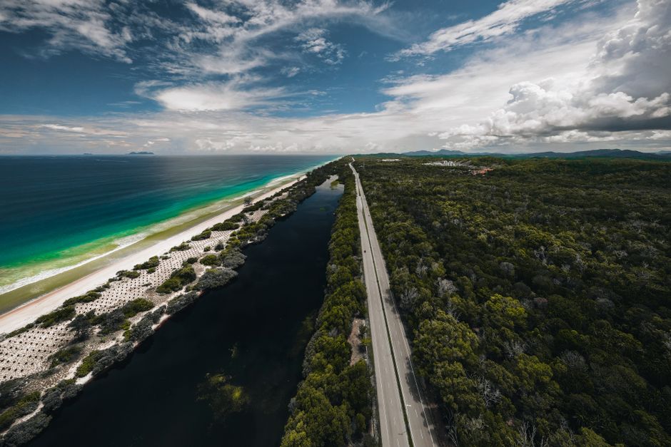 Scenic aerial view of a beach, road, and forest in Marang, Terengganu, Malaysia.