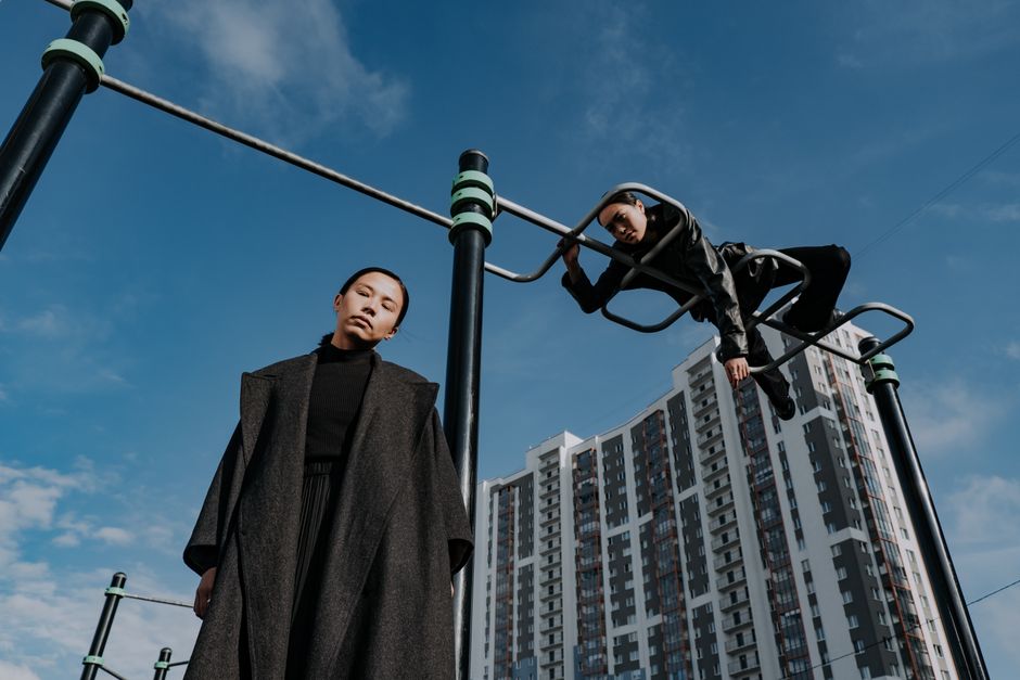 Stylish portrait of women in urban setting against a blue sky.