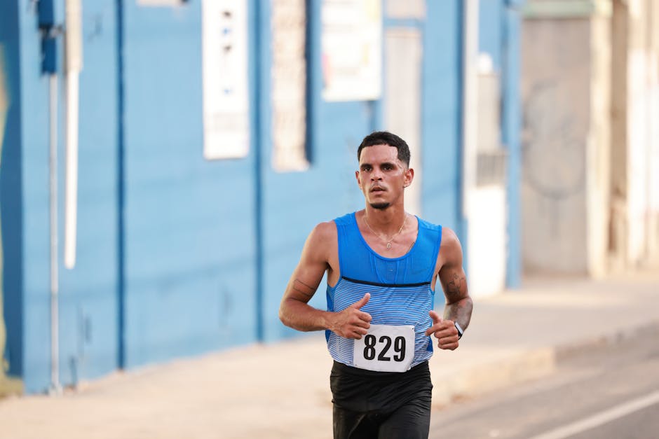A determined athlete running in a marathon on urban city streets, wearing a numbered bib.