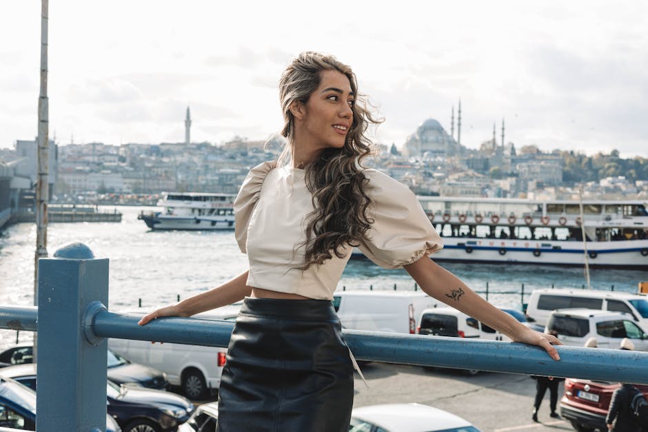 A woman with long curly hair enjoys a scenic view by the Bosphorus in Istanbul, Turkey.